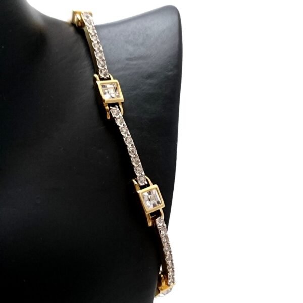 gold-toned tennis bracelet featuring three larger rectangular stones